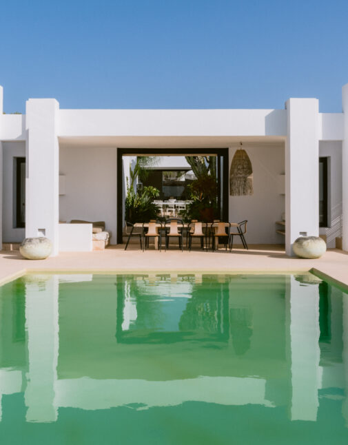 Eye-catching André Jacqmain villa for sale, reflected in its expansive pool